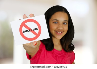 Teen Girl Holding A Card That Says No Bullying