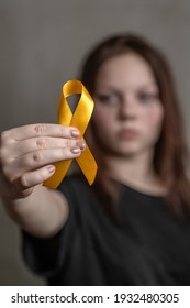 Teen Girl Holds Yellow Ribbon. Concept Of Suicide Problems And Their Prevention 
