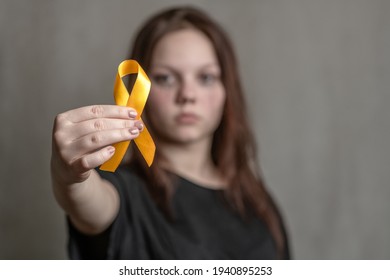 Teen Girl Holds Yellow Ribbon. Concept Of Suicide Problems And Their Prevention 