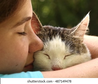 teen girl hug cat close up monochrome portrait on the summer garden background - Powered by Shutterstock