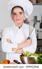 Teen Girl In The Kitchen Preparing A Salad