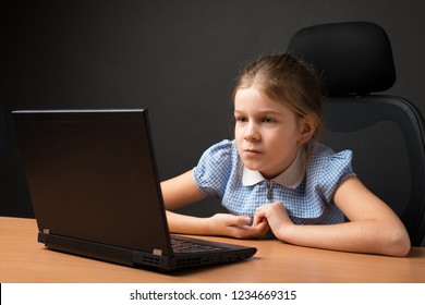 Teen Girl With A Laptop On A Dark Background. Child Safety Online