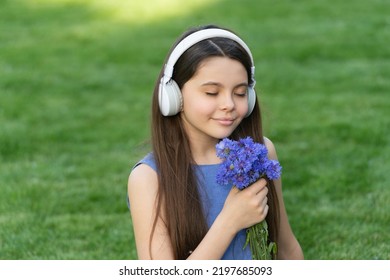 Teen Girl Listen Music. Child In Wireless Music Headphones. Kid Listening To Music Smell Flowers