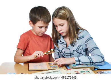 Teen girl and little boy with magnifier looking his stamp collection isolated - Powered by Shutterstock