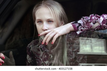 Teen Girl Looking Through Car Window