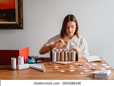 Teen Girl Making Handmade Advent Calendar House From Toilet Paper Rolls And Carton Box. Sustainable Christmas, Upcycling, Zero Waste, Affordable Gift.