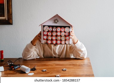 Teen Girl Making Handmade Advent Calendar House From Toilet Paper Rolls And Carton Box. Sustainable Christmas, Upcycling, Zero Waste, Affordable Gift.