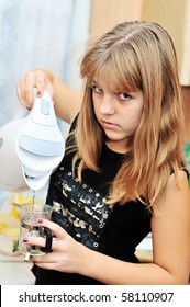 Teen Girl On The Kitchen Making Tea