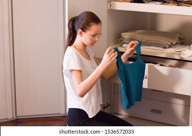 Teen Girl Order The Linens In The Closet. Concept Of Order, Cleanliness In Wardrobe And Home, Collaboration Of The Teenagers To Keep The Home Environments Tidy.