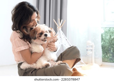 Teen girl playing having fun with her pet dog on floor, Shih Tzu puppy and teen girl play fun at home, lovely pet - Powered by Shutterstock