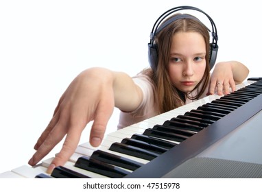 Teen Girl Plays On A Musical Synthesizer