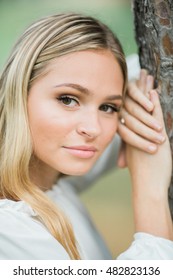 Teen Girl Poses For A High School Senior Portrait Photo Outdoors By Tree