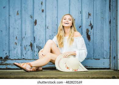 Teen Girl Poses For A High School Senior Portrait Photo Outdoors With Wooden Blue Background