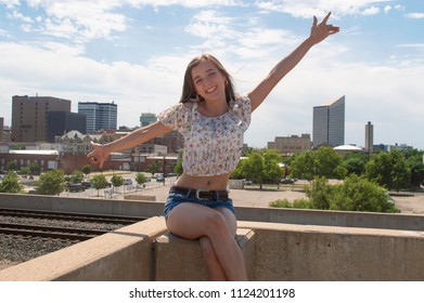 Teen Girl Posing with Wichita Skyline