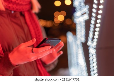 Teen Girl In A Red Cap Talking On The Phone At Night On The Street.