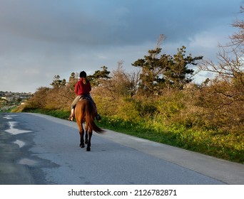 Teen Girl Riding A Horse. Unknown Woman Riding Horse On Country Road