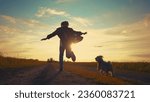 teen girl running with dog in the park. happy family freedom a kid dream concept. silhouette of a teenage girl running along the road in the park at sunset view from the back sun with a shaggy dog