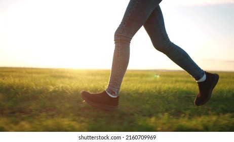 Teen Girl Running Legs Close Up. Happy Family A Kid Dream Concept. Teenage Daughter Runs Barefoot On The Grass Road In The Park Field In The Summer Close-up Legs. Legs Lifestyle Run Girl Concept