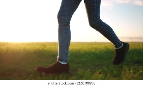 Teen Girl Running Legs Close Up. Happy Family A Kid Dream Concept. Teenage Daughter Runs Barefoot On The Grass Road In The Park Field In The Summer Lifestyle Close-up Legs. Legs Run Girl Concept