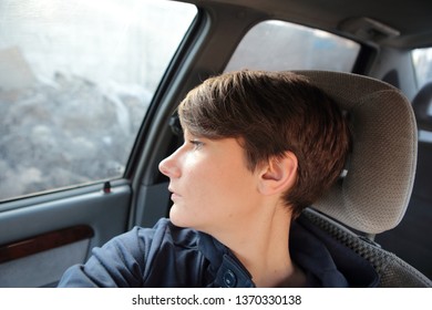 Teen Girl Selfie In The Car On The Seat Looks Out The Window