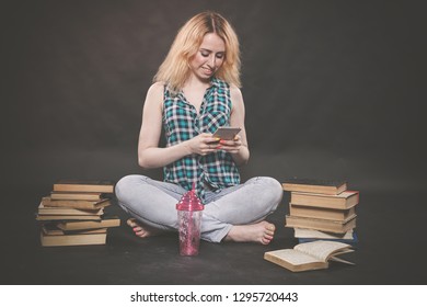 Teen Girl Sitting On The Floor Next To Books, Does Not Want To Learn, Drinking Juice And Taking A Selfie On The Smartphone