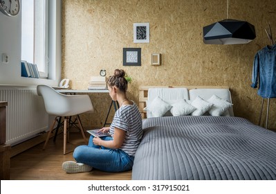 Teen Girl Sitting On The Floor In Her Bedroom