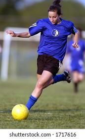 Teen Girl Soccer Player Is About To Kick Yellow Soccer Ball