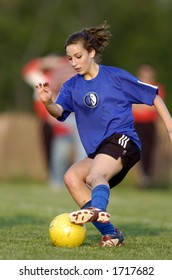 Teen Girl Soccer Player Makes A Move With A Yellow Soccer Ball