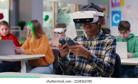 Teen Girl Student Using Vr Headset And Remote Controllers In Classroom. Schoolgirl Study In Virtual Reality Goggles