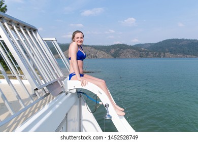 Teen Girl Swimming Down Water Slide At A Lake