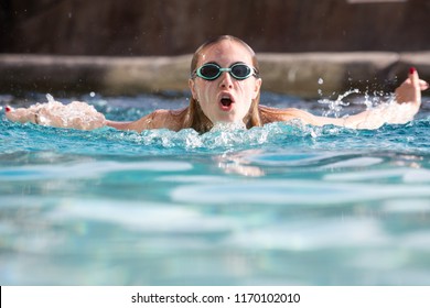 Teen Girl Swimming  In Pool