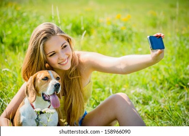 Teen Girl Taking Photo Of Herself And Her Dog With Mobile Phone Camera