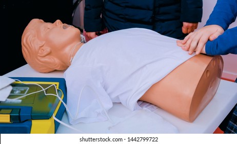 Teen Girl Trying Resuscitation Technique On Dummy. First Aid Reanimation, CRP Training, Medicine, Healthcare And Medical Concept