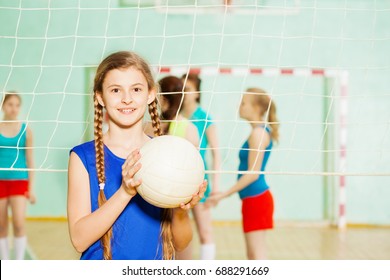 Teen Girl With Volleyball Ball In Sports Hall