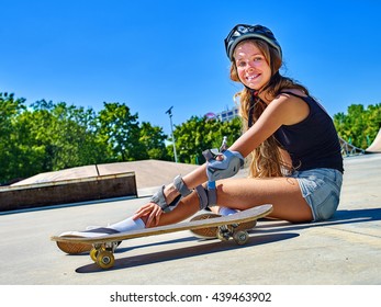 Teen Girl Wearing Skateboard Helmet Fall Down Near Her Skateboard Outdoor.