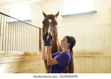 Teen girl wearing a vibrant purple shirt is gently petting a beautiful brown horse, creating a serene and heartwarming scene - Powered by Shutterstock