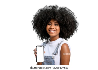 Teen Girl Without Face Shield Holds The Cell Phone Close To Her Arm With The Vaccine Sticker, Looking At Camera,  Fully Immunized