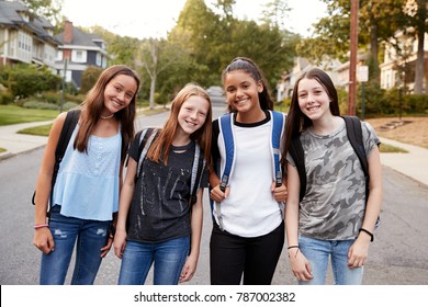 Teen girls on the way to school looking to camera, close up