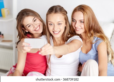 teen girls with smartphone taking selfie at home - Powered by Shutterstock