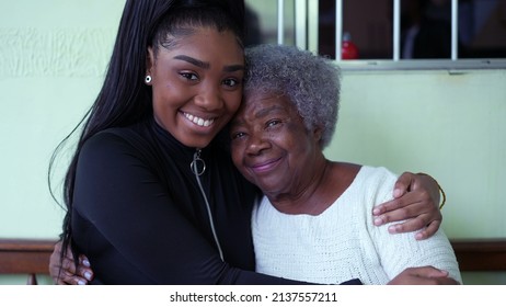 A teen granddaughter embracing grandmother a black girl embraces grandparent