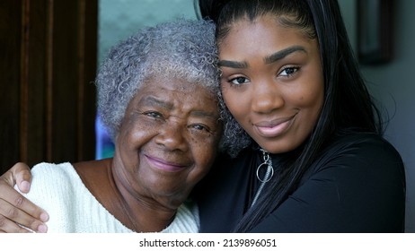 A teen granddaughter embracing grandmother a black girl embraces grandparent - Powered by Shutterstock