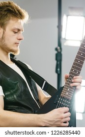 Teen Hardcore Man Wearing Metal Outfit Playing On Electric Guitar Heavy Rock Music Teen Hardcore Man Wearing Metal Outfit Playing On Electric Guitar Heavy Rock Music