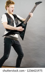 Teen Hardcore Man Wearing Metal Outfit Playing On Electric Guitar Heavy Rock Music Having Yelling Screaming Teen Hardcore Man Wearing Metal Outfit Playing On Electric Guitar Heavy Rock Music Having Yelling Screaming