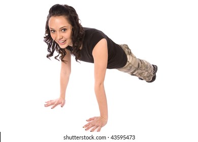 A Teen In Her Army Clothes Working Out Doing Push Ups With A Smile On Her Face.