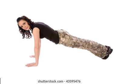 A Teen In Her Army Clothes Working Out Doing Push Ups With A Serious Look On Her Face.