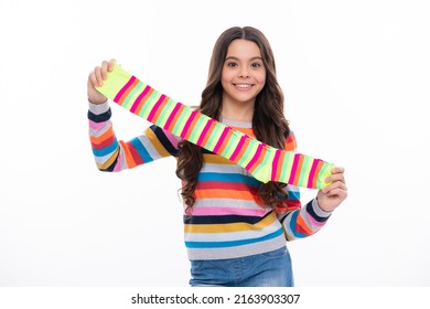 Teen hold strip sock on white background. Child holding a pair of stripped socks.