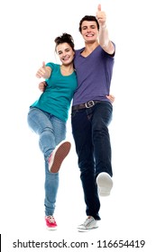 Teen Love Couple Enjoying Themselves, Gesturing Thumbs Up. All Against White Background