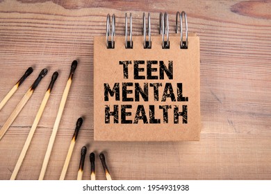 Teen Mental Health. Burnt Matches And Notepad On A Wooden Background.