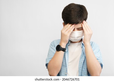 Teen Mental Health During COVID-19 Concept. Portrait Of An Asian Teenager Boy With Medical Face Mask, Face Down Hands Cover His Face. Stressful, Anxiety, Illness, Infected, Cyberbully, Pandemic.