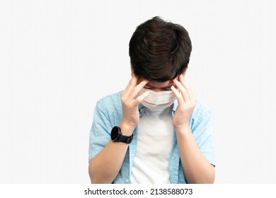 Teen Mental Health During COVID-19 Concept. Portrait Of An Asian Teenager Boy With Medical Face Mask, Face Down Hands Cover His Face. Stressful, Anxiety, Illness, Infected, Cyberbully, Pandemic.